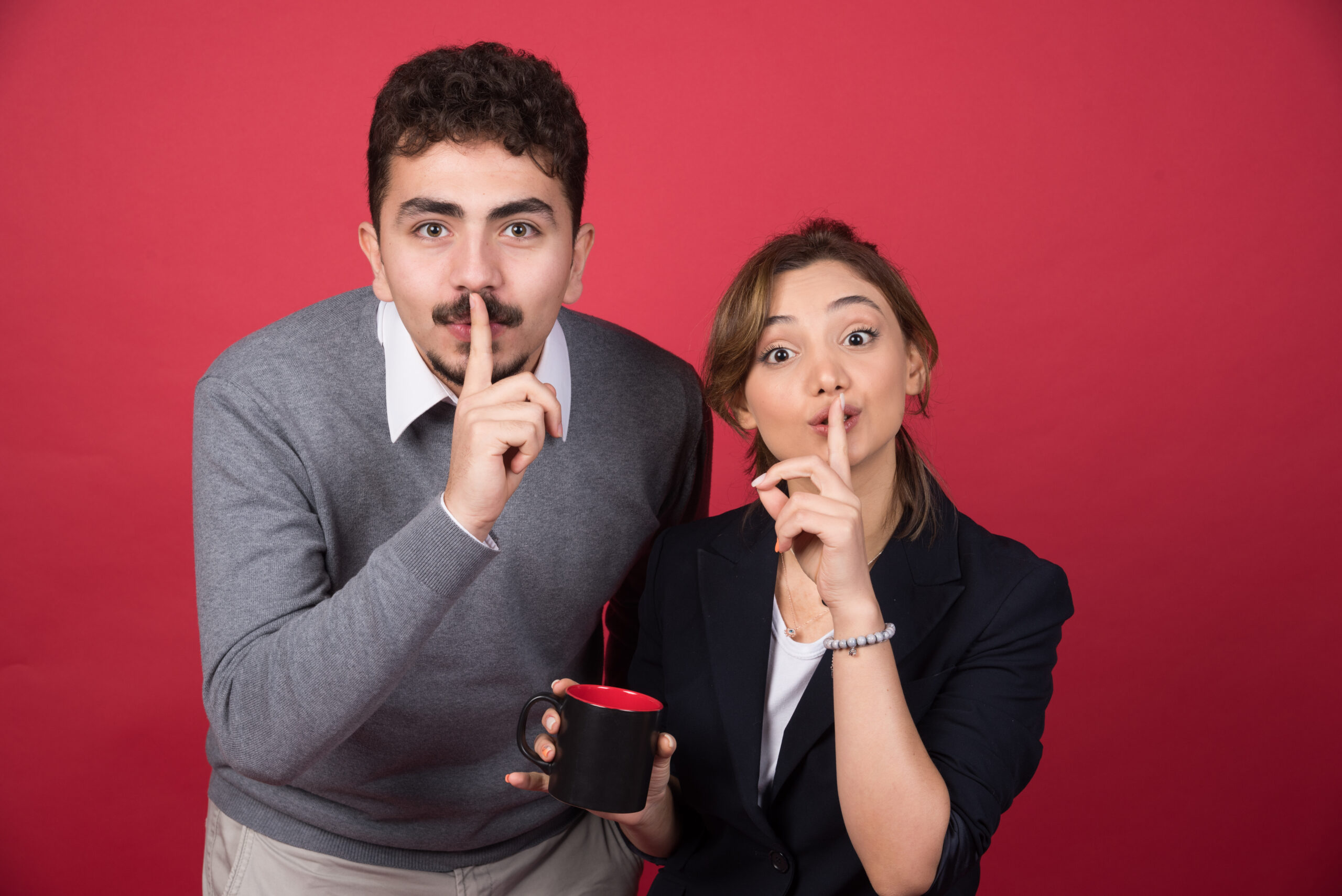 Two-business-partners-giving hint-of-something-secret